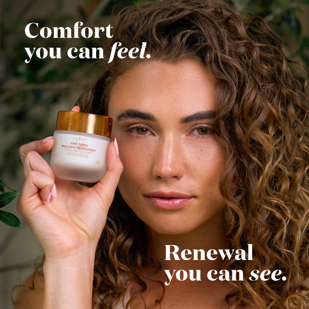 A woman with curly brown hair holds up a jar of Moisturizer against a soft, blurred green background. White text overlays read 'Comfort you can feel.