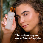 A woman holds a frosted bottle of Toner next to her face, with the text 'The softest way to smooth-looking skin' at the bottom.