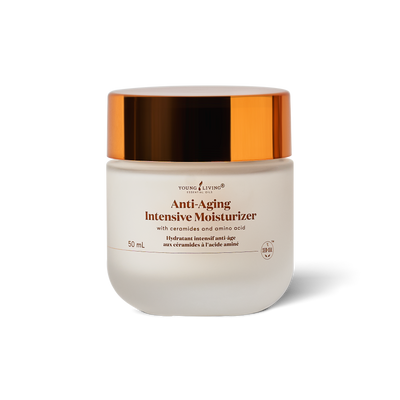 A 50 mL jar of Young Living Anti-Aging Intensive Moisturizer, featuring a frosted white glass container and a reflective metallic copper lid, set against a clean white background with a soft shadow.