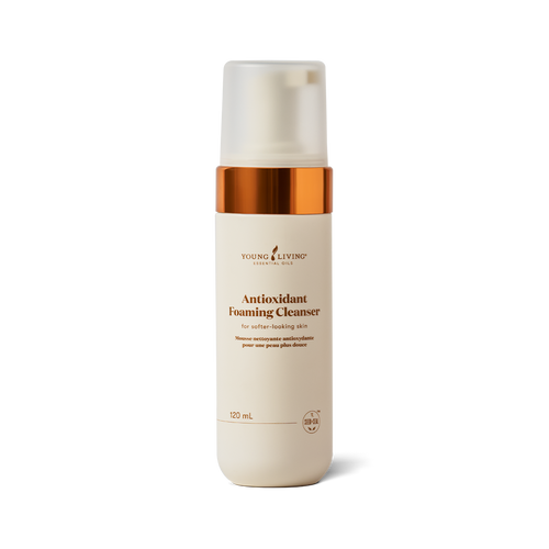 A 120 mL bottle of Young Living Antioxidant Foaming Cleanser on a clean white background. The bottle is cream-colored with a metallic copper collar and a frosted cap.