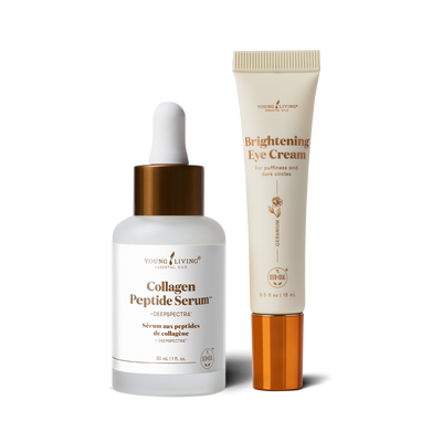 Two skincare products from Young Living on a white background: a Collagen Peptide Serum dropper bottle with a white and gold cap, and a Brightening Eye Cream tube with a cream-colored body and gold cap.