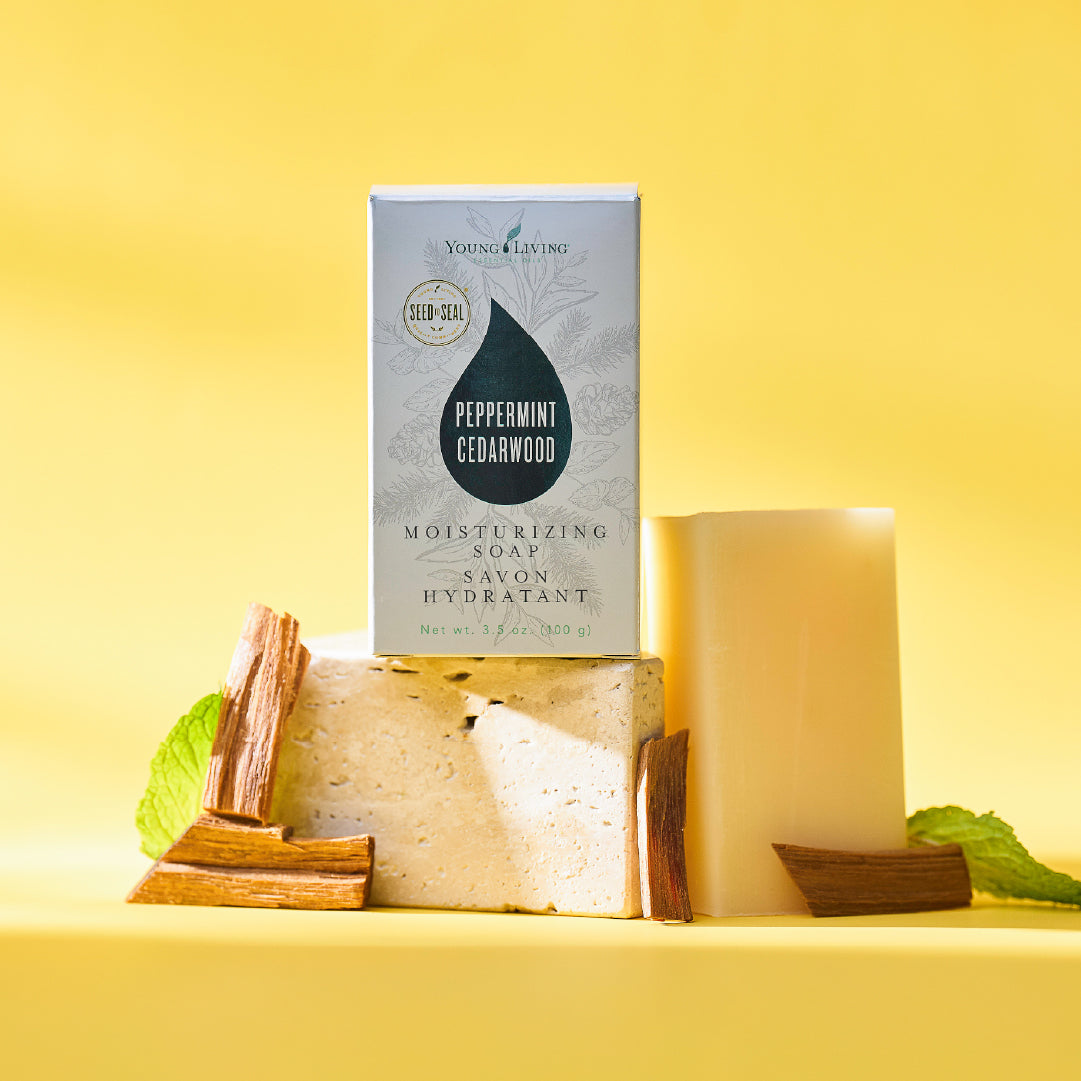 Young Living Peppermint Cedarwood soap bar with packaging on a yellow background
