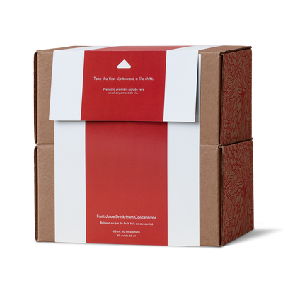 brown cardboard box wrapped with a red and white paper sleeve. The sleeve features white text that reads 'Take the first sip toward a life shift.