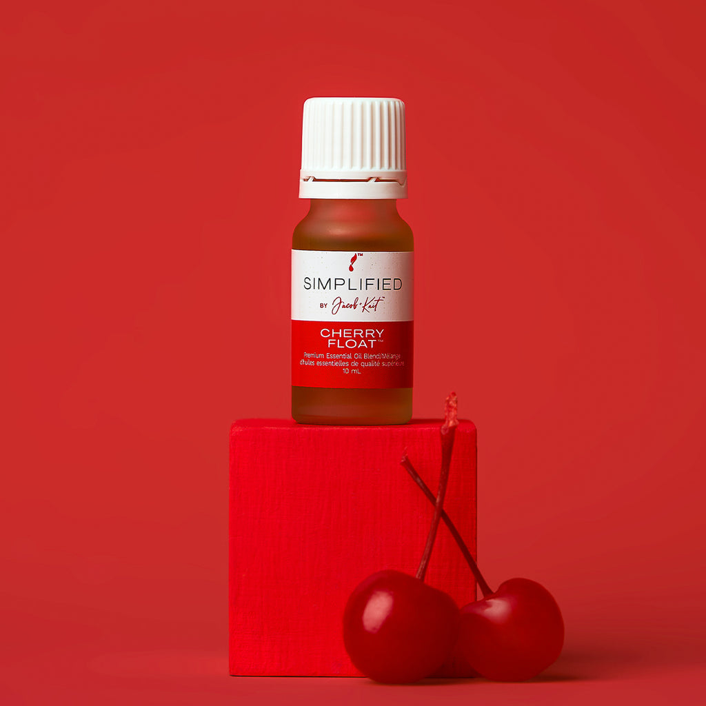 Bottle of 'Simplified' Cherry Float on a red background with two cherries.