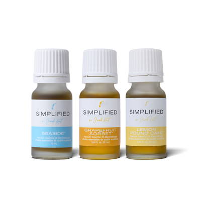 Three small glass essential oil bottles of Simplified by Jacob + Kait : Seaside, Grapefruit Sorbet, and Lemon Pound Cake.