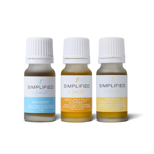 Three small glass essential oil bottles of Simplified by Jacob + Kait : Seaside, Grapefruit Sorbet, and Lemon Pound Cake.