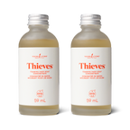 Two bottles of Thieves foaming hand soap concentrate by Young Living on a white background.