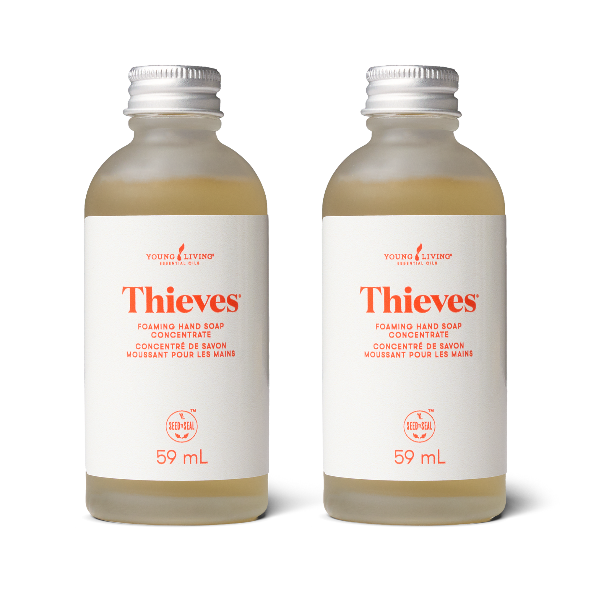 Two bottles of Thieves foaming hand soap concentrate by Young Living on a white background.