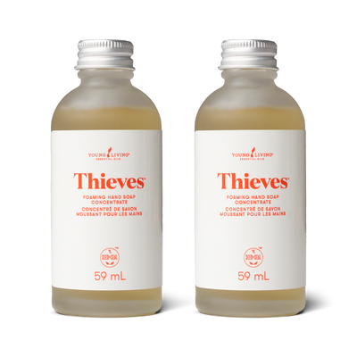 Two bottles of Thieves foaming hand soap concentrate by Young Living on a white background.