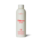 White bottle of Thieves Cleaner with red text on a white background